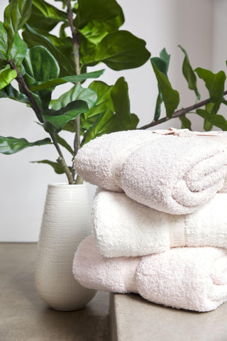 Barefoot Dreams CozyChic Throw Stone in a living room setup