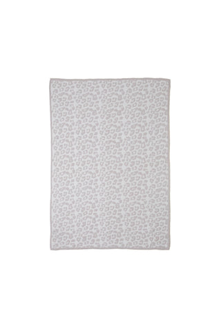Barefoot Dreams CozyChic wild throw laid over a bed in neutral tones