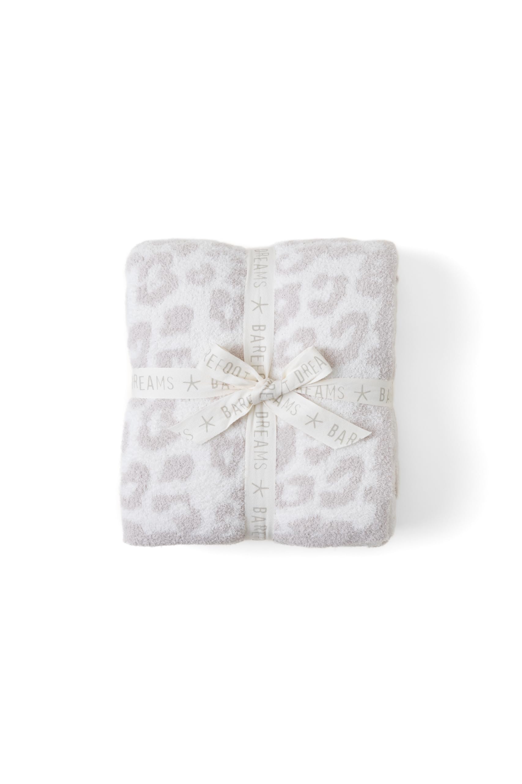 Barefoot Dreams CozyChic throw draped on a sofa in cream-stone for cozy evenings