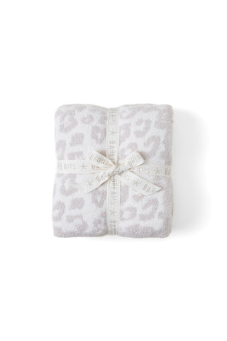 Barefoot Dreams CozyChic throw draped on a sofa in cream-stone for cozy evenings