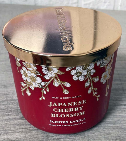 The glow of Bath & Body Works Japanese Cherry Blossom 3-Wick Candle creates a warm, inviting ambiance.