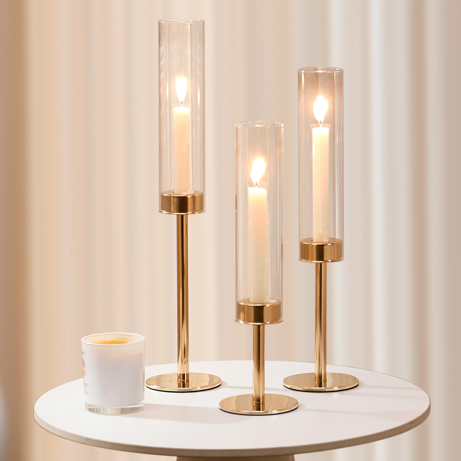 Batoslee gold hurricane candle holder outdoor dining setup in breeze