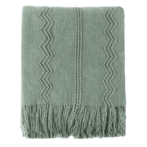 Battilo Home sage green throw on sofa highlights cozy texture for everyday lounging.