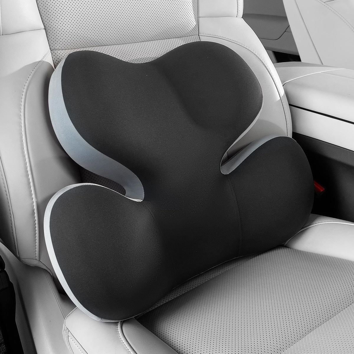 BEBAS lumbar support pillow on car seat with ergonomic contour for comfort.