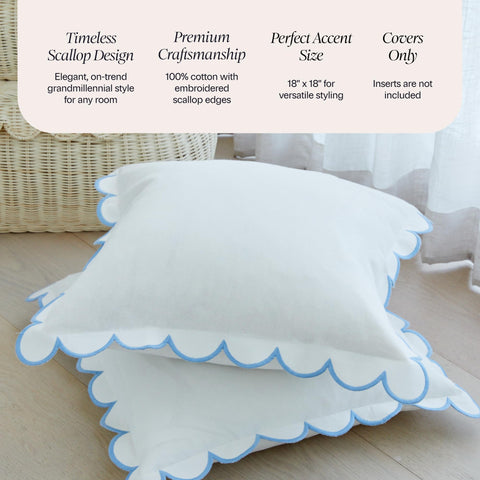 White and blue Margot scalloped pillow cover 18x18 on a neutral bed setup.