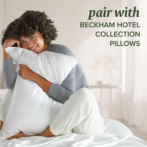 Beckham Hotel Collection neatly stacked queen protectors on bed for quick replacement.