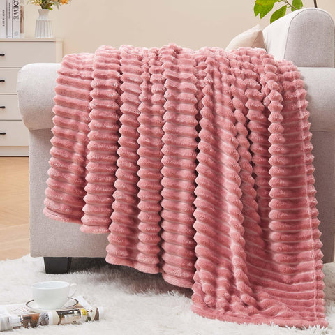 BEDELITE fleece blanket pink folded on couch showing cozy warmth and texture