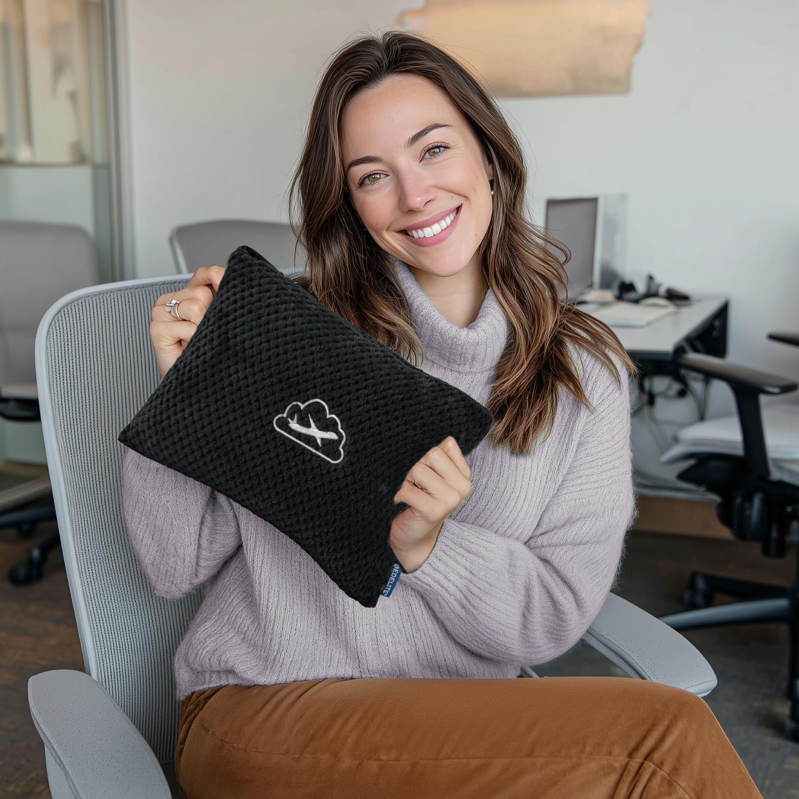 BEDELITE travel blanket attached to luggage sleeve for hands-free travel.