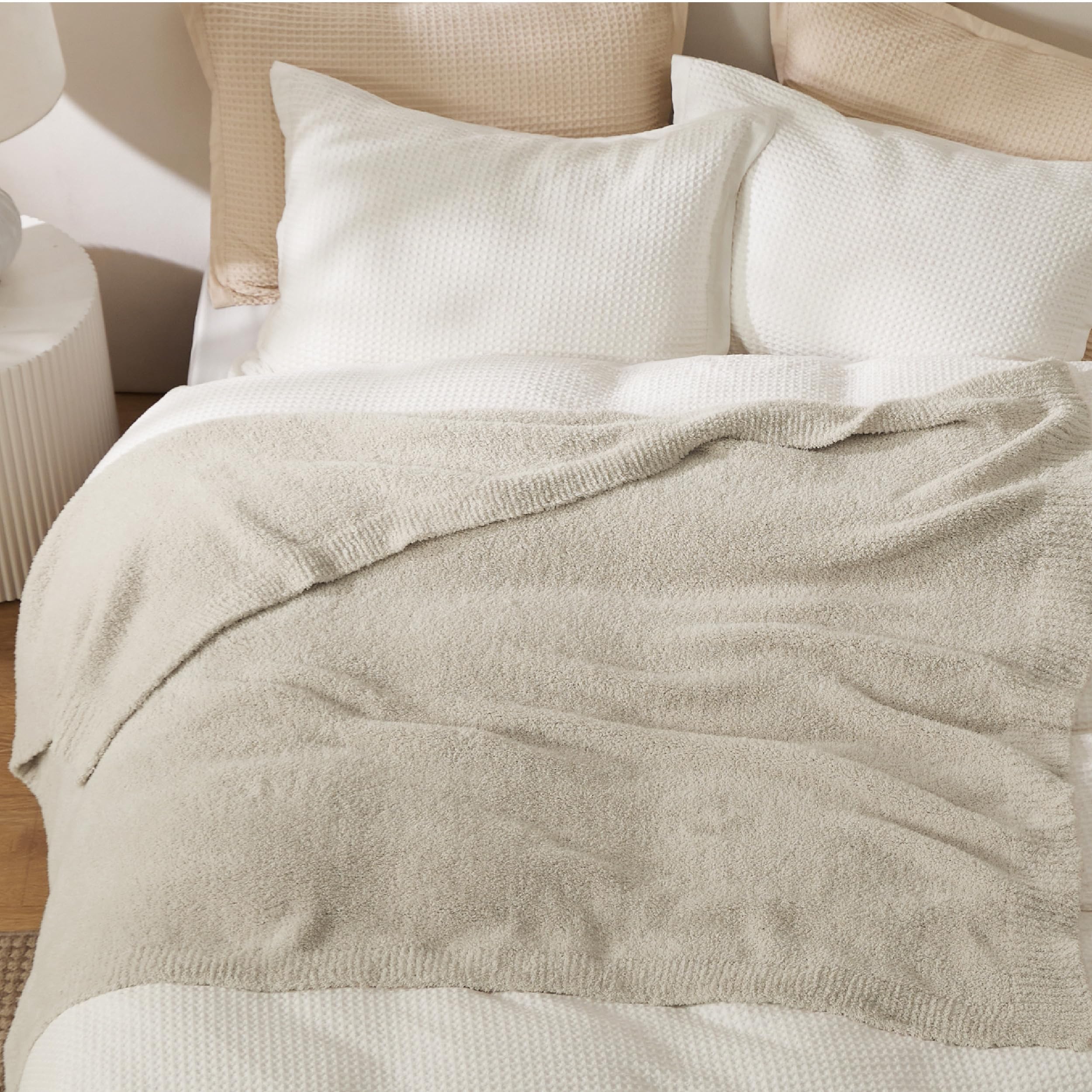 Bedsure beige knit throw used on bed for extra snuggling warmth.