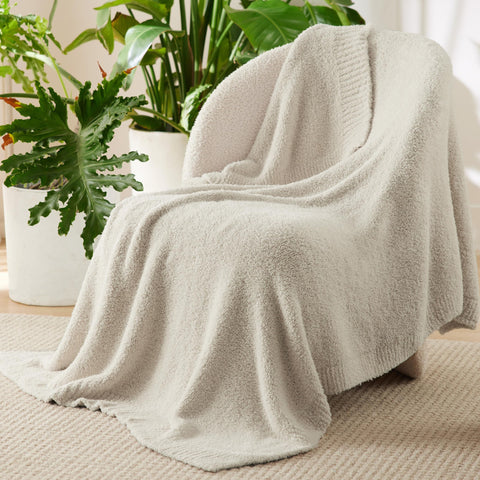 Bedsure beige knit throw blanket on sofa adds warmth without heaviness.