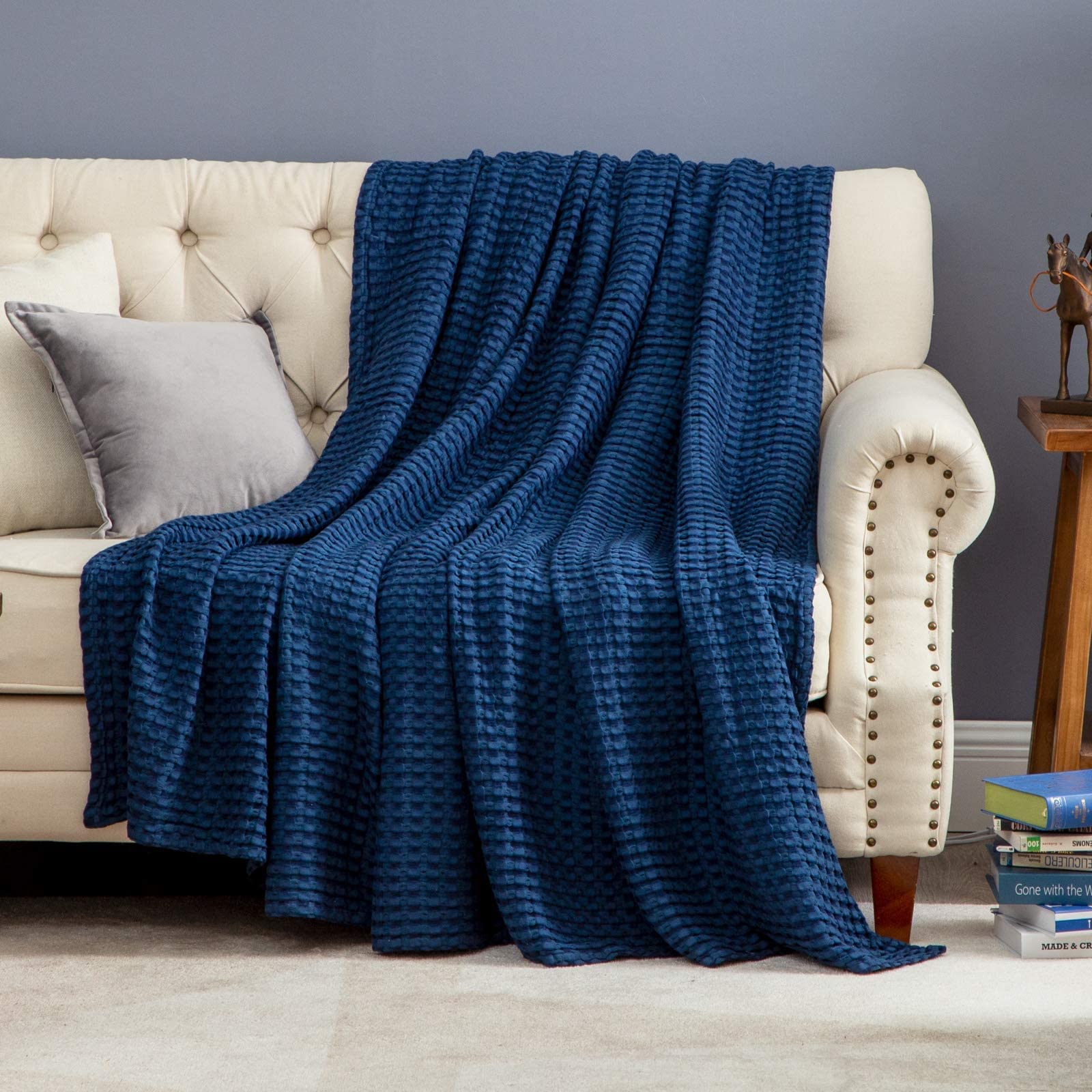 Bedsure blanket on couch and bed demonstrates versatile home use in navy.