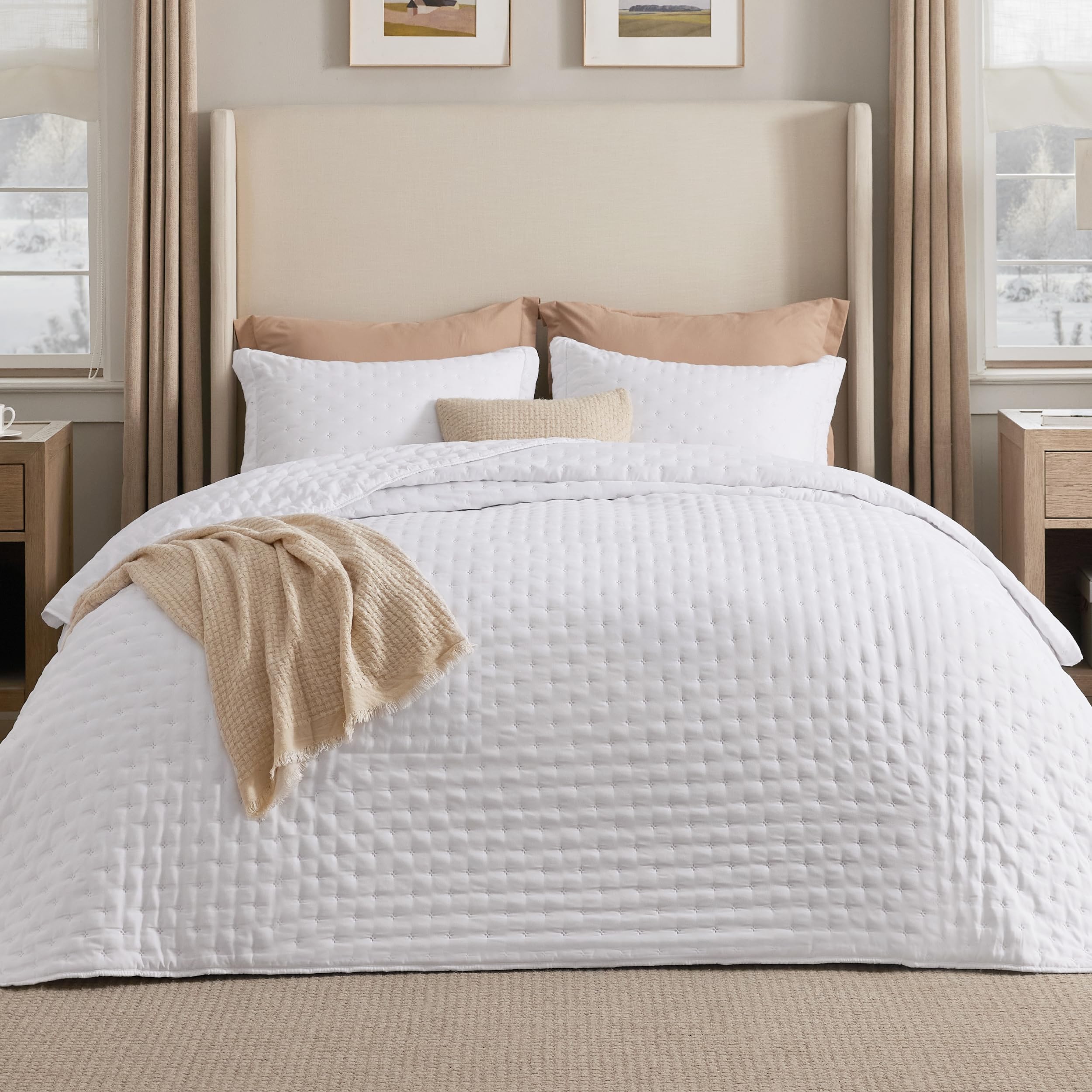 Bedsure California King quilt bright white on bed, all-season comfort.