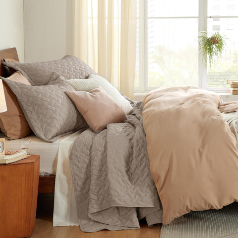 Bedsure quilt seen from angle shows generous drape on bed
