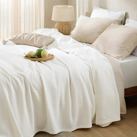 Bedsure cooling blanket layered on bed for summer lounging.