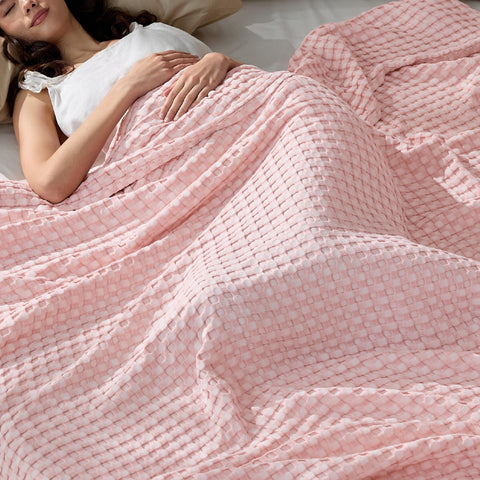 Bedsure cooling cotton waffle blanket in spring pink draped over a bed, ideal for hot sleepers.