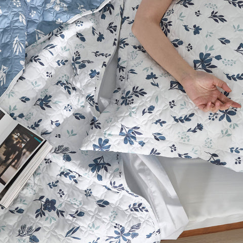 Bedsure blue and white floral comforter on a neatly made bed for a fresh look.