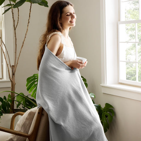 Bedsure GentleSoft cool grey blanket in living room shows breathable cotton for all-season comfort.