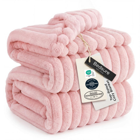 Bedsure GentleSoft coral pink blanket on couch showing plush fleece for cozy evenings