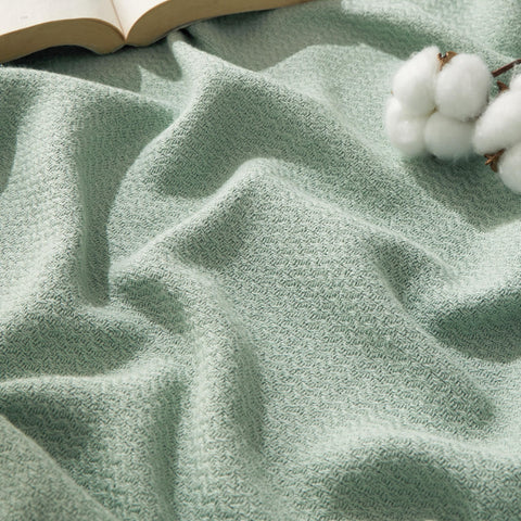Bedsure GentleSoft cotton throw in sage green for couch warmth and breathable comfort.