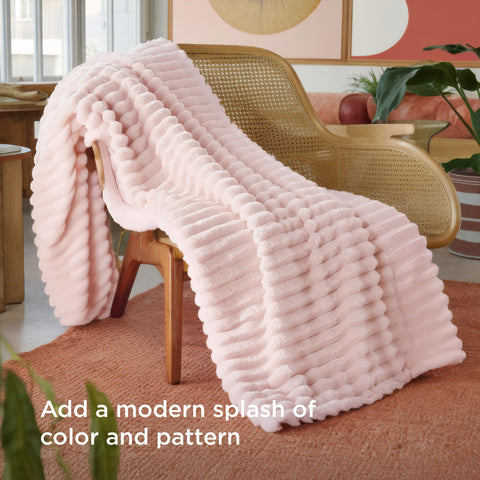 Bedsure GentleSoft crystal pink throw draped over bed for relaxing evenings.