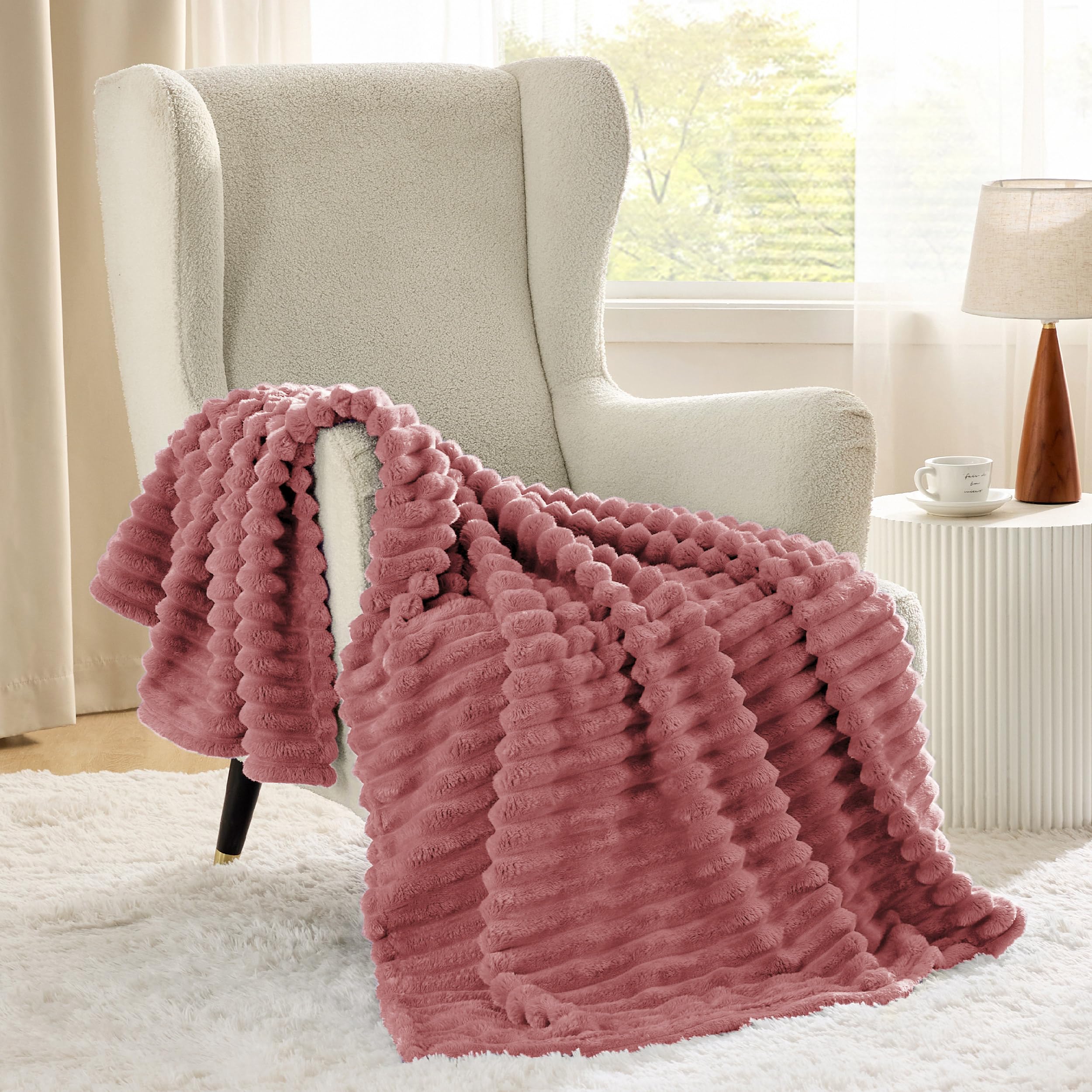 Bedsure GentleSoft Dusty Pink throw on a couch for cozy lounging