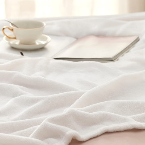 Bedsure GentleSoft fleece blanket on living room sofa for movie nights