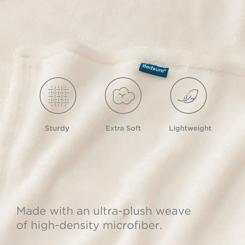 Bedsure GentleSoft fleece blanket on bed in cream demonstrates lightweight warmth.