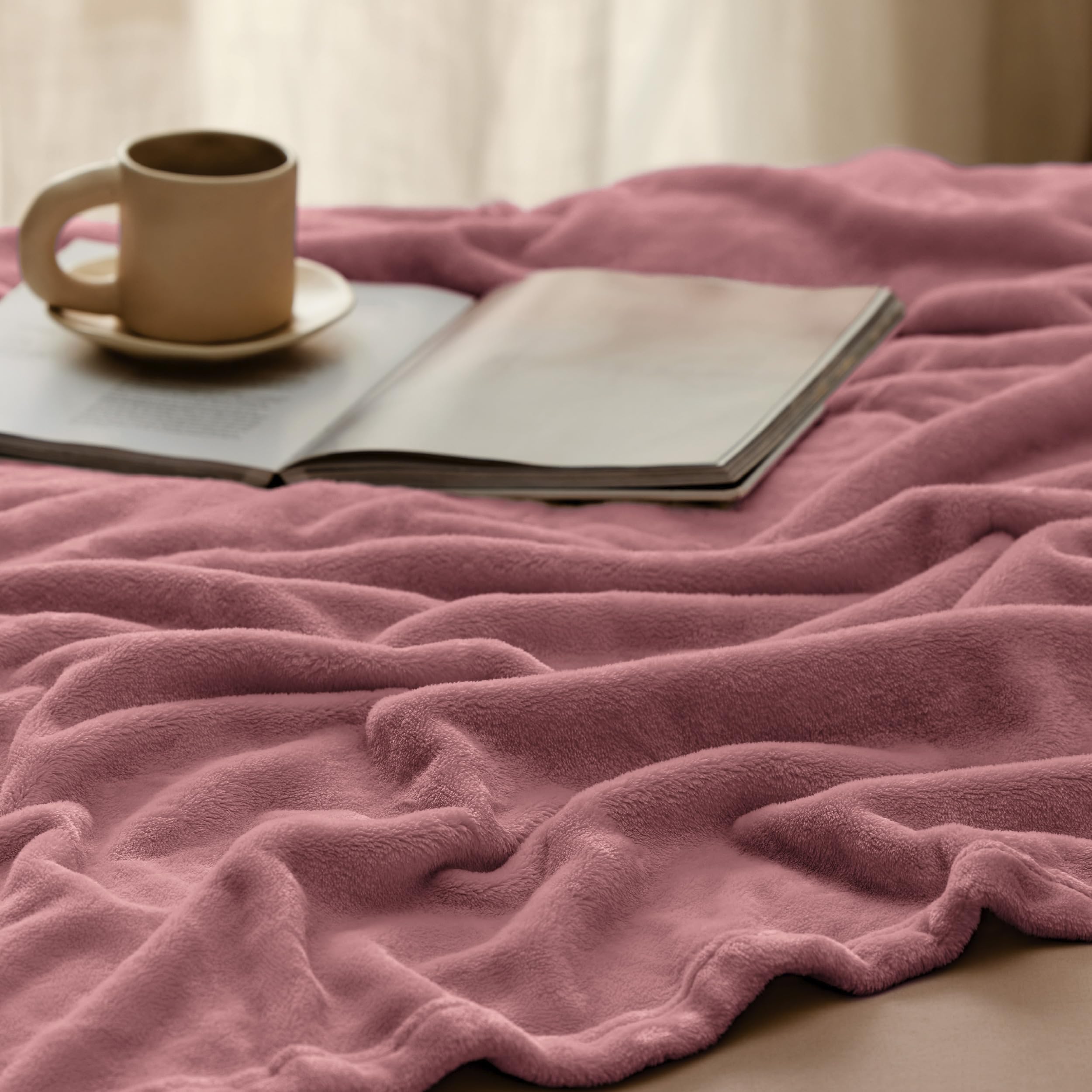 Bedroom decor with Bedsure GentleSoft fleece blanket in dusty rose hue.