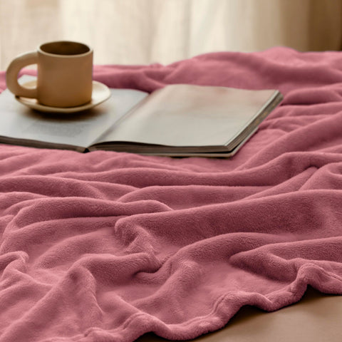 Bedroom decor with Bedsure GentleSoft fleece blanket in dusty rose hue.