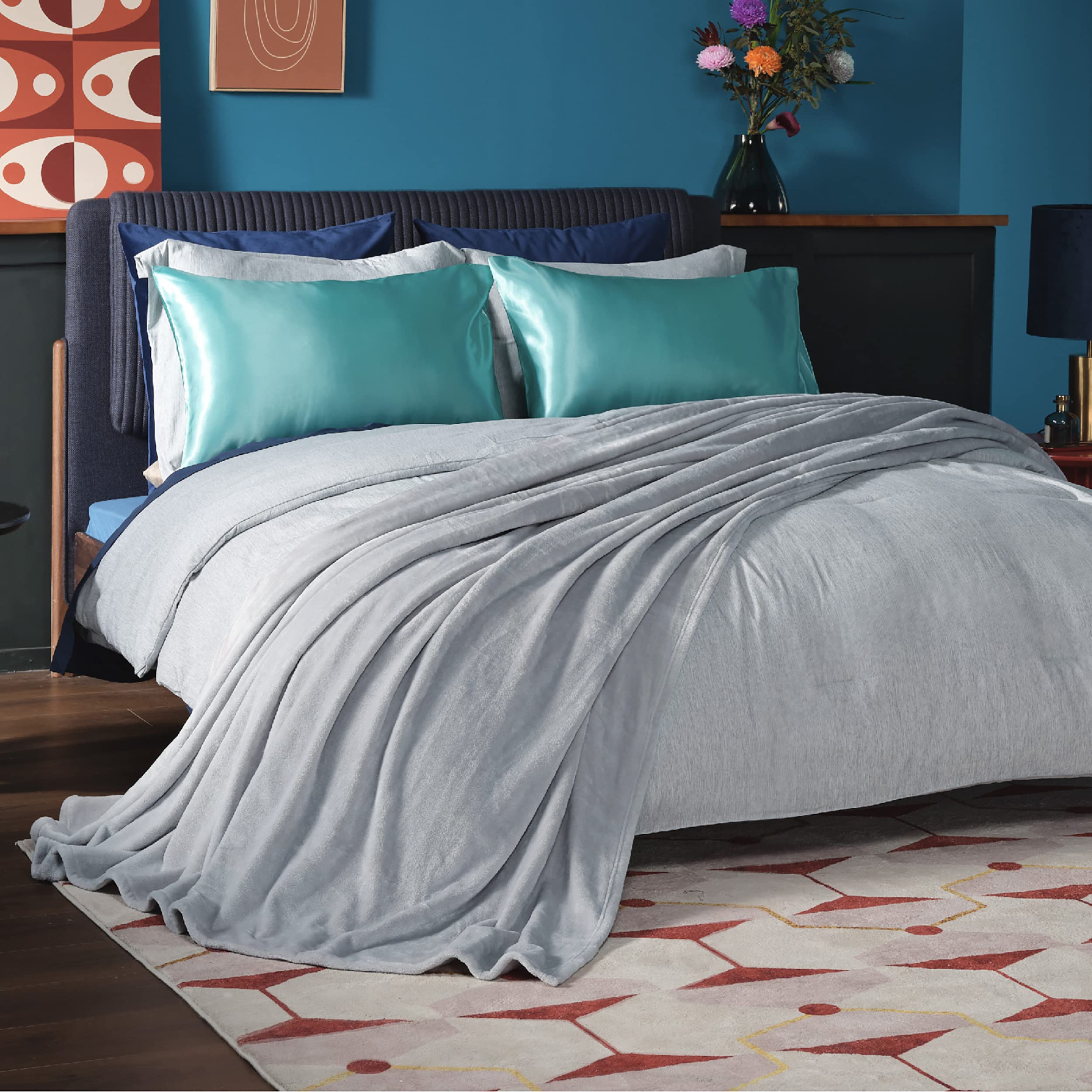 Bedsure GentleSoft fleece blanket draped on bed in light grey for cozy warmth.