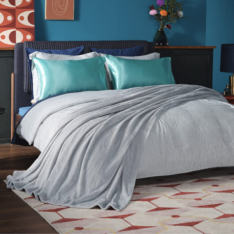 Bedsure GentleSoft fleece blanket draped on bed in light grey for cozy warmth.