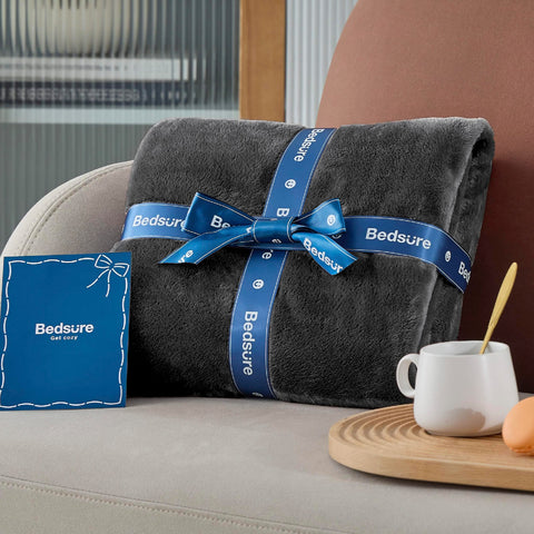 Bedsure GentleSoft fleece blanket on sofa in charcoal full-size for lounging