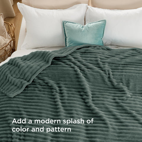 Model drapes Bedsure GentleSoft Mallard Green for warm comfort