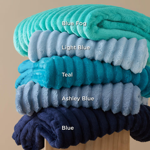 Bedsure GentleSoft navy blanket paired with pillows for cozy living spaces.