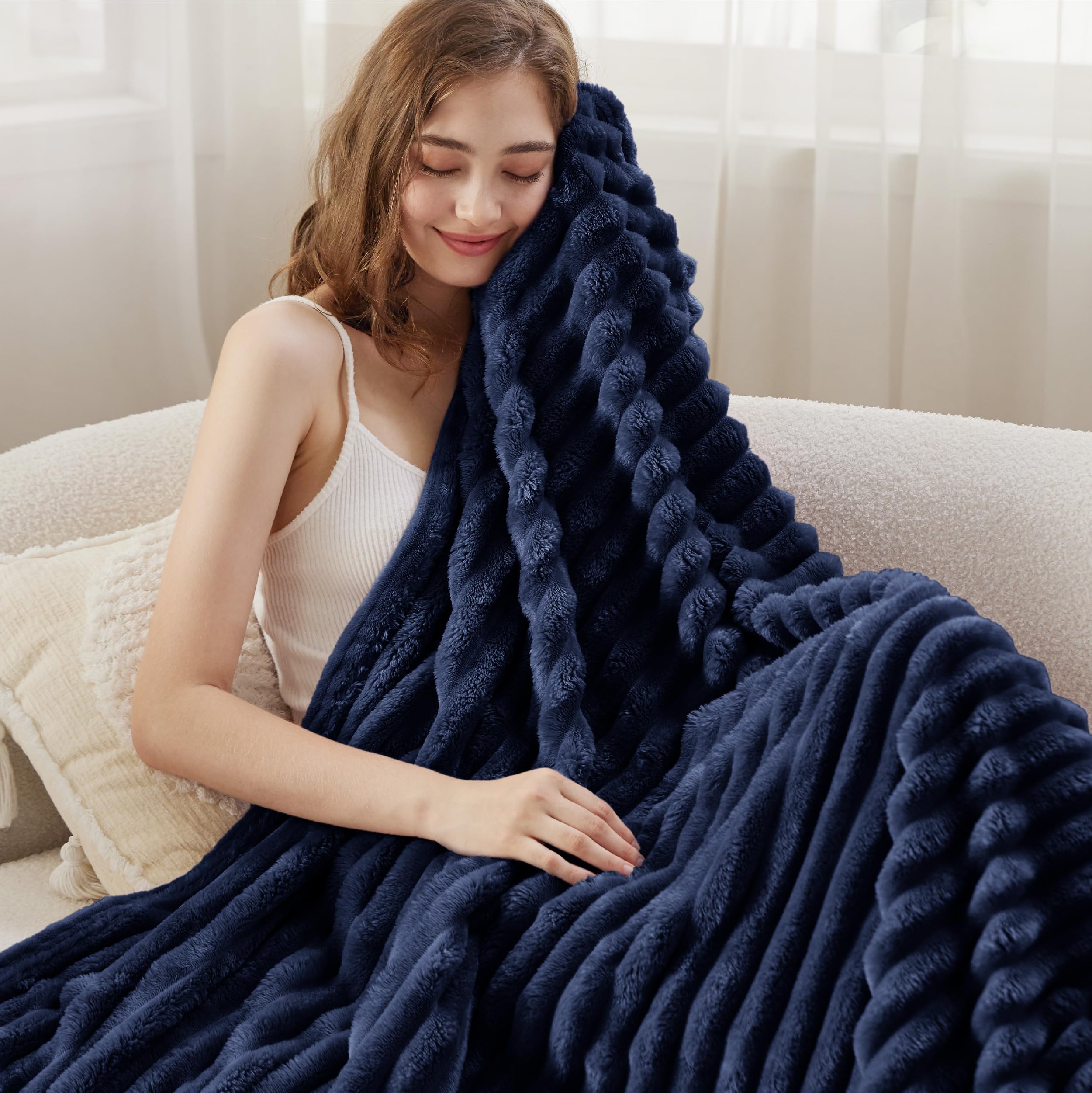 Bedsure GentleSoft navy blanket wrapped cozy for reading or TV time.