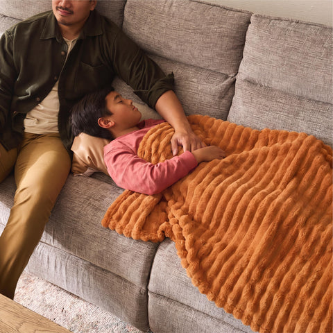 Bedsure GentleSoft orange throw adds cozy color to any room.
