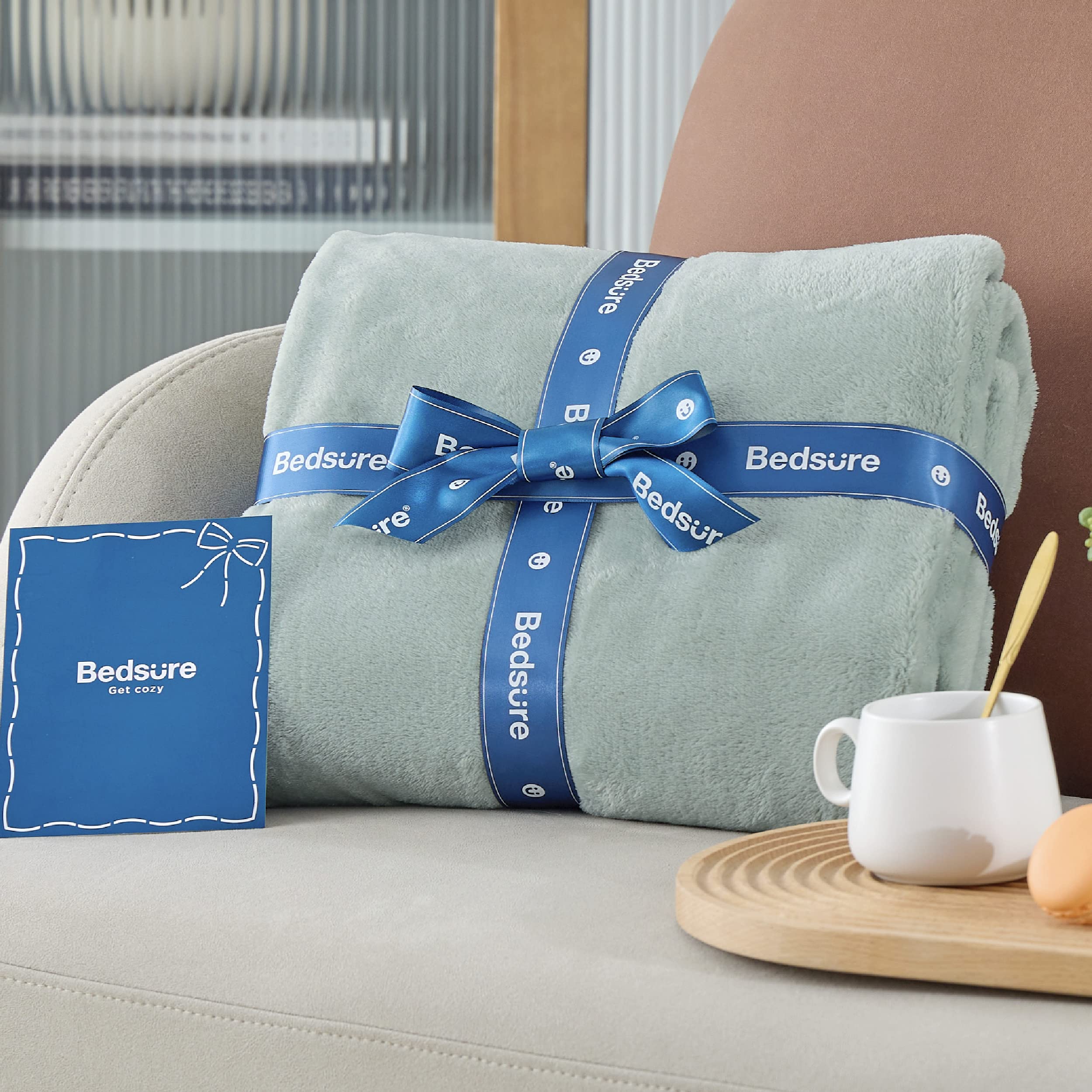 Bedsure GentleSoft sage green blanket for travel use on a plane or car