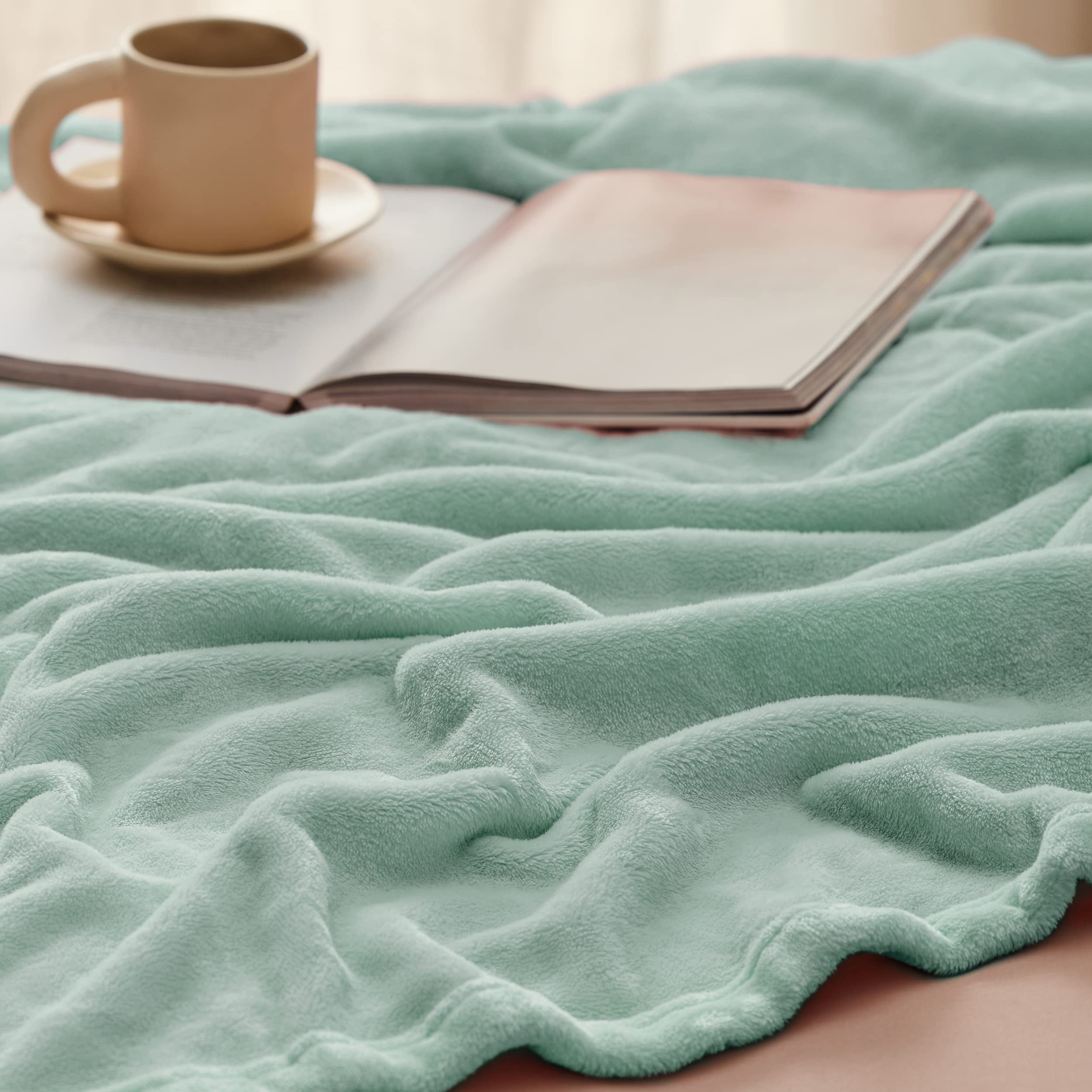 Bedsure GentleSoft sage green blanket ready for travel use
