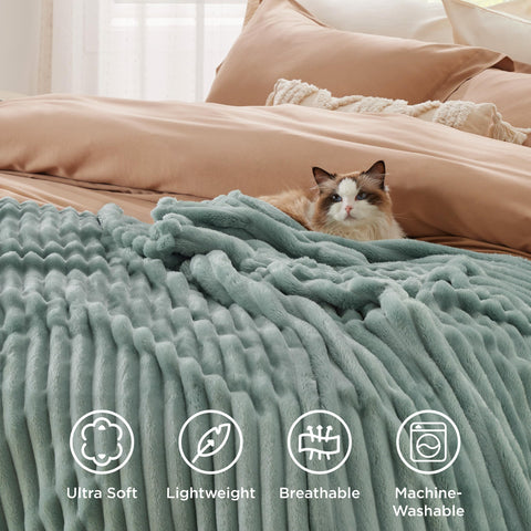 Family enjoys movie night with Bedsure GentleSoft fleece blanket on the sofa