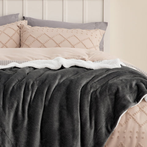 Bedsure GentleSoft Sherpa blanket in charcoal color on sofa adds cozy decor and warmth