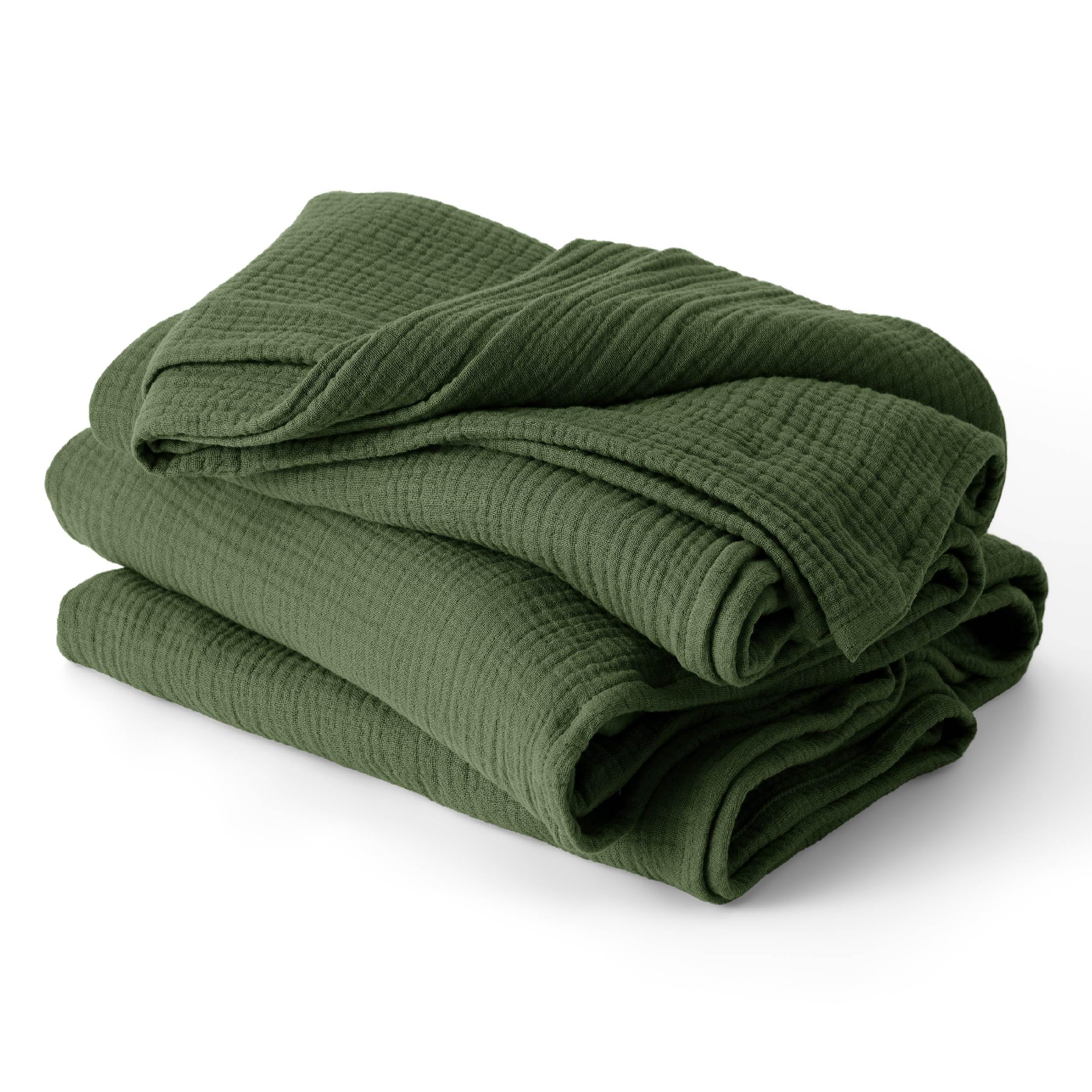 Bedsure muslin blanket in olive green on bed, breathable and lightweight for summer comfort.