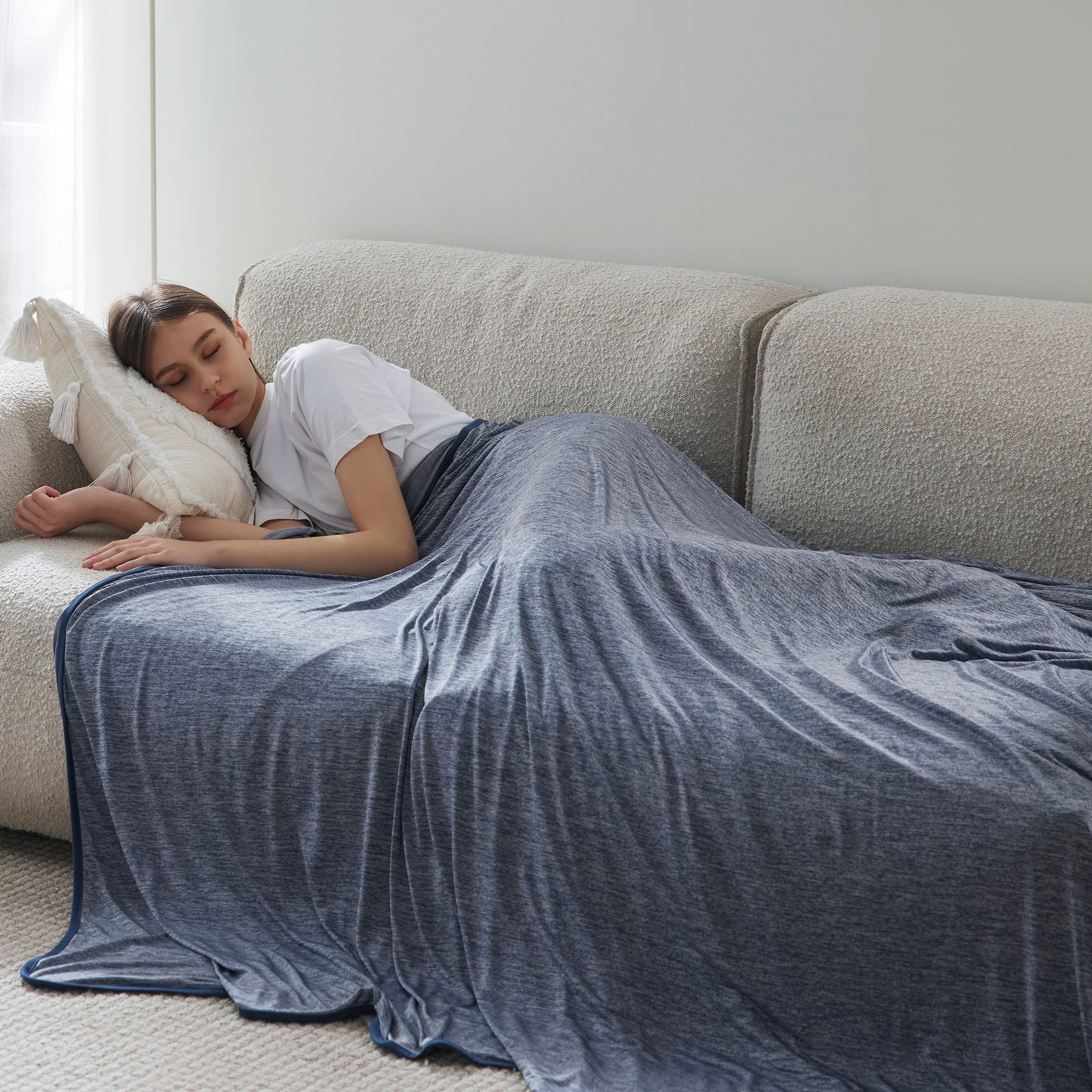Bedsure navy blue 50x70 blanket spread on bed for cooling comfort.