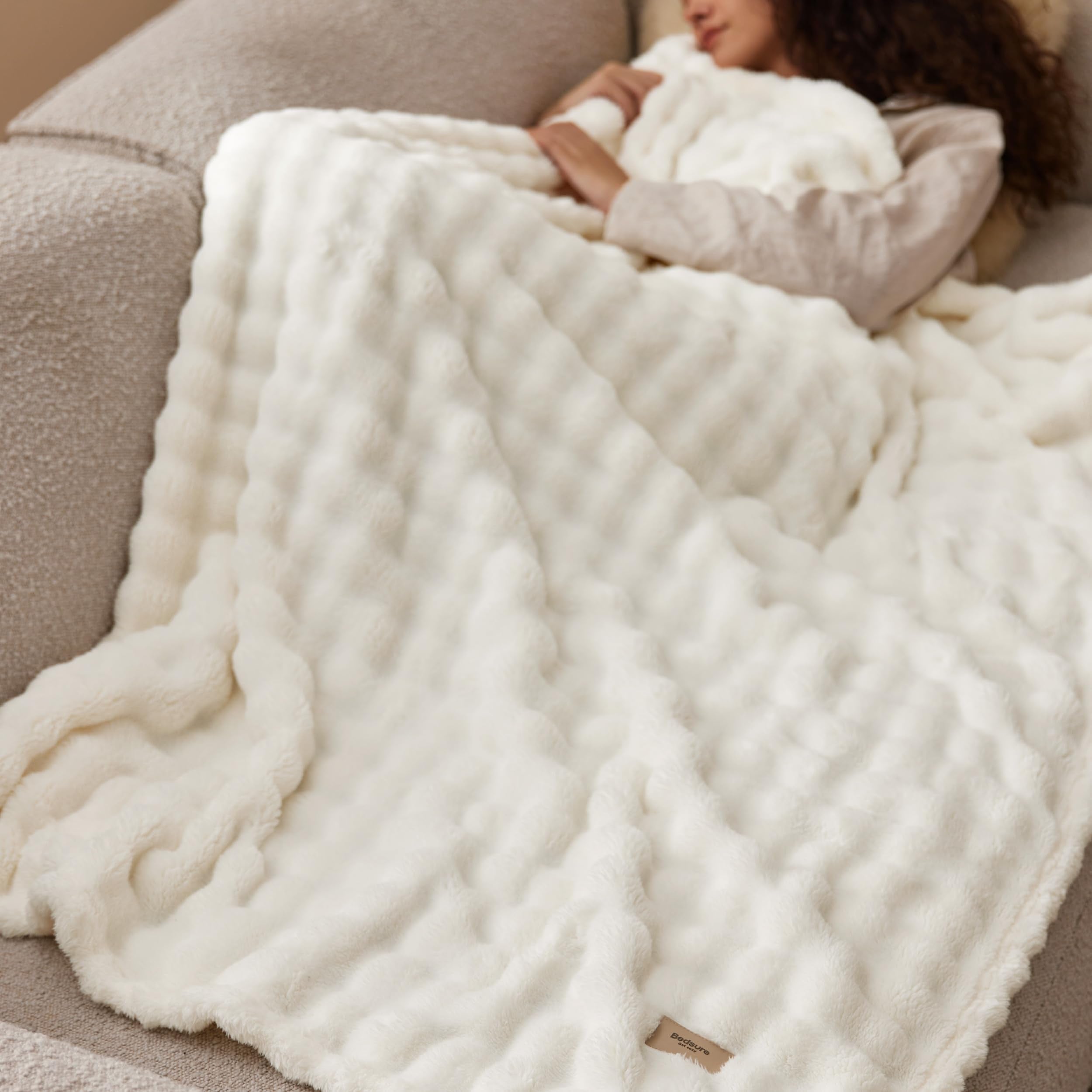 Bedsure off-white blanket complements neutral living room decor palettes.