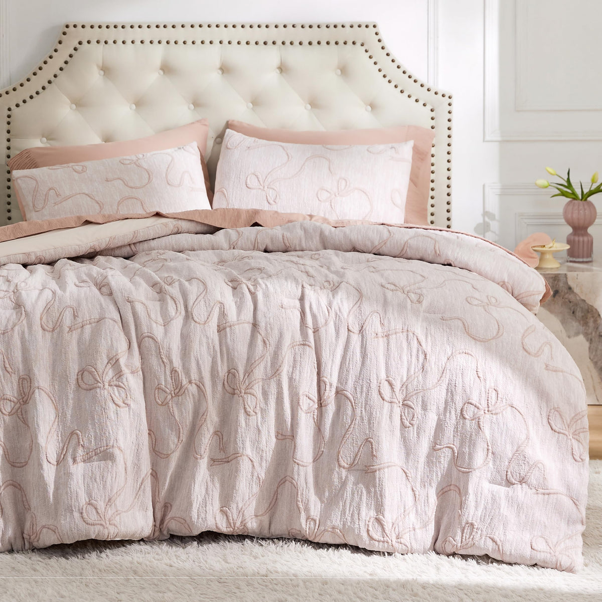 Bedsure pink twin-xl comforter with bow pattern adds charming bedroom decor.