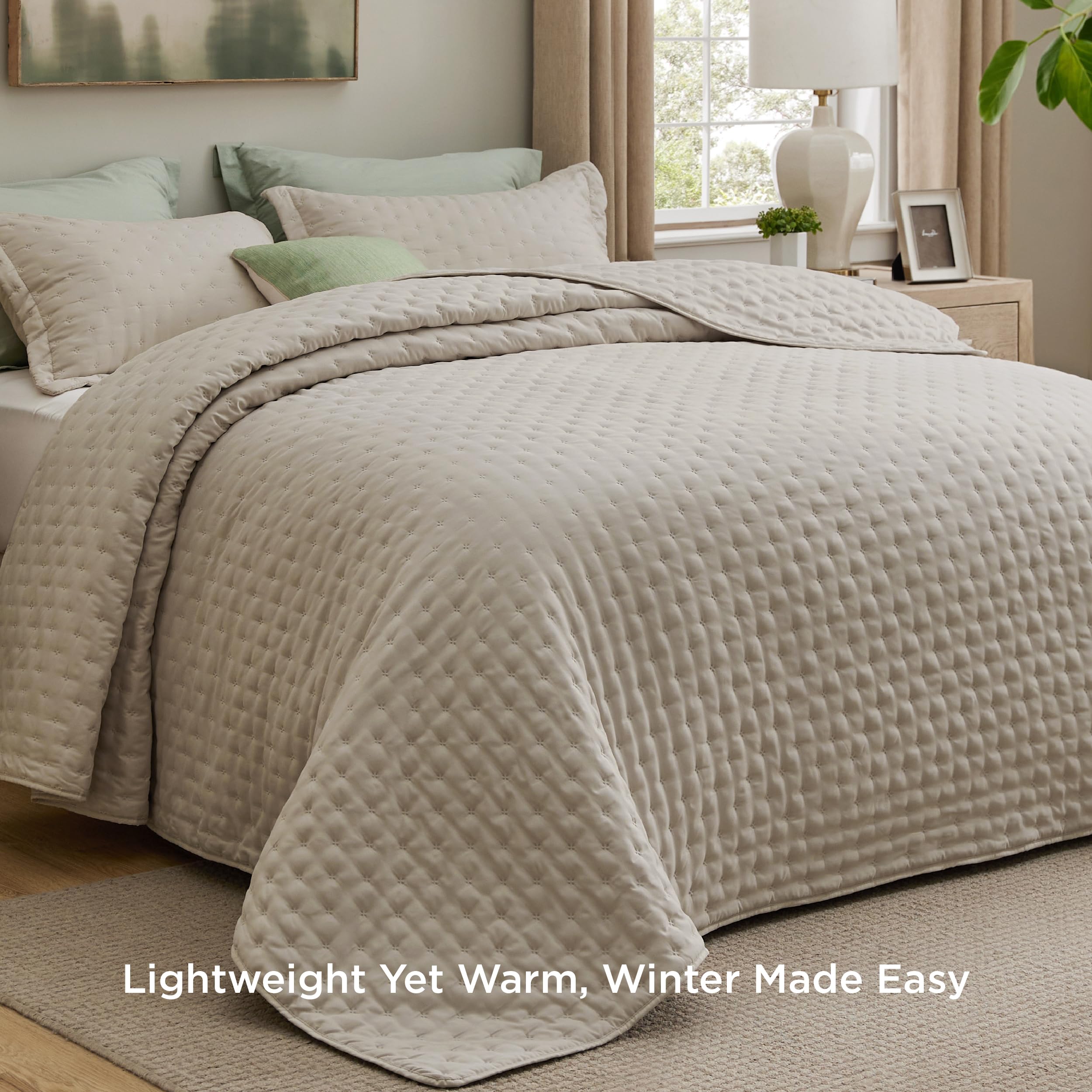 Bedsure quilt close-up shows embossed clover pattern and texture.