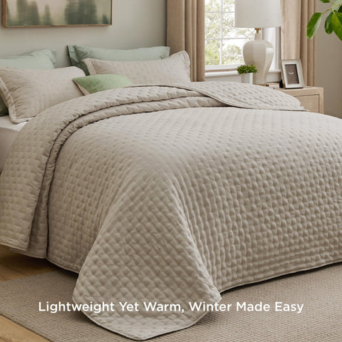 Bedsure quilt close-up shows embossed clover pattern and texture.