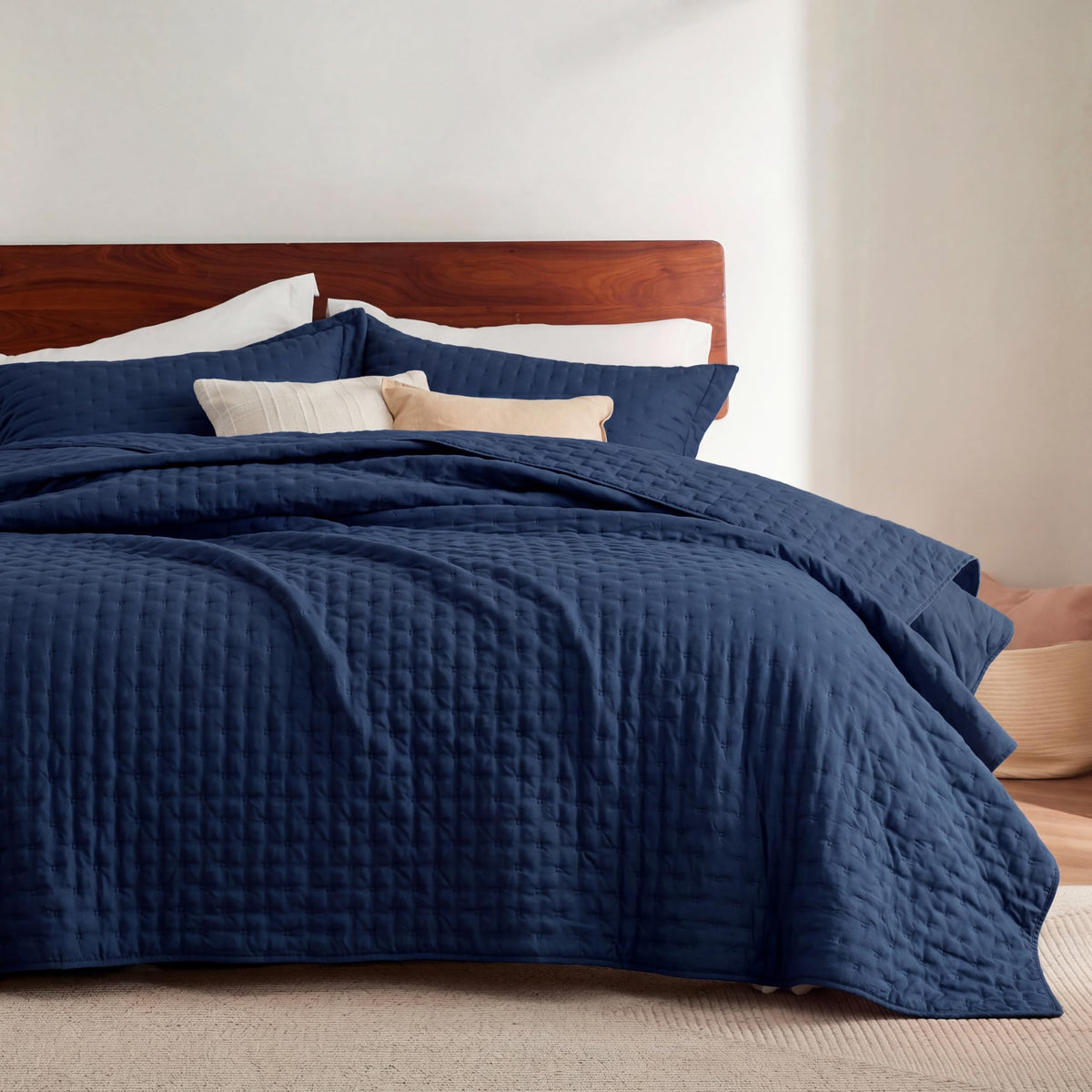 Bedsure quilt in navy with embossed pattern for a calm, modern bedroom.