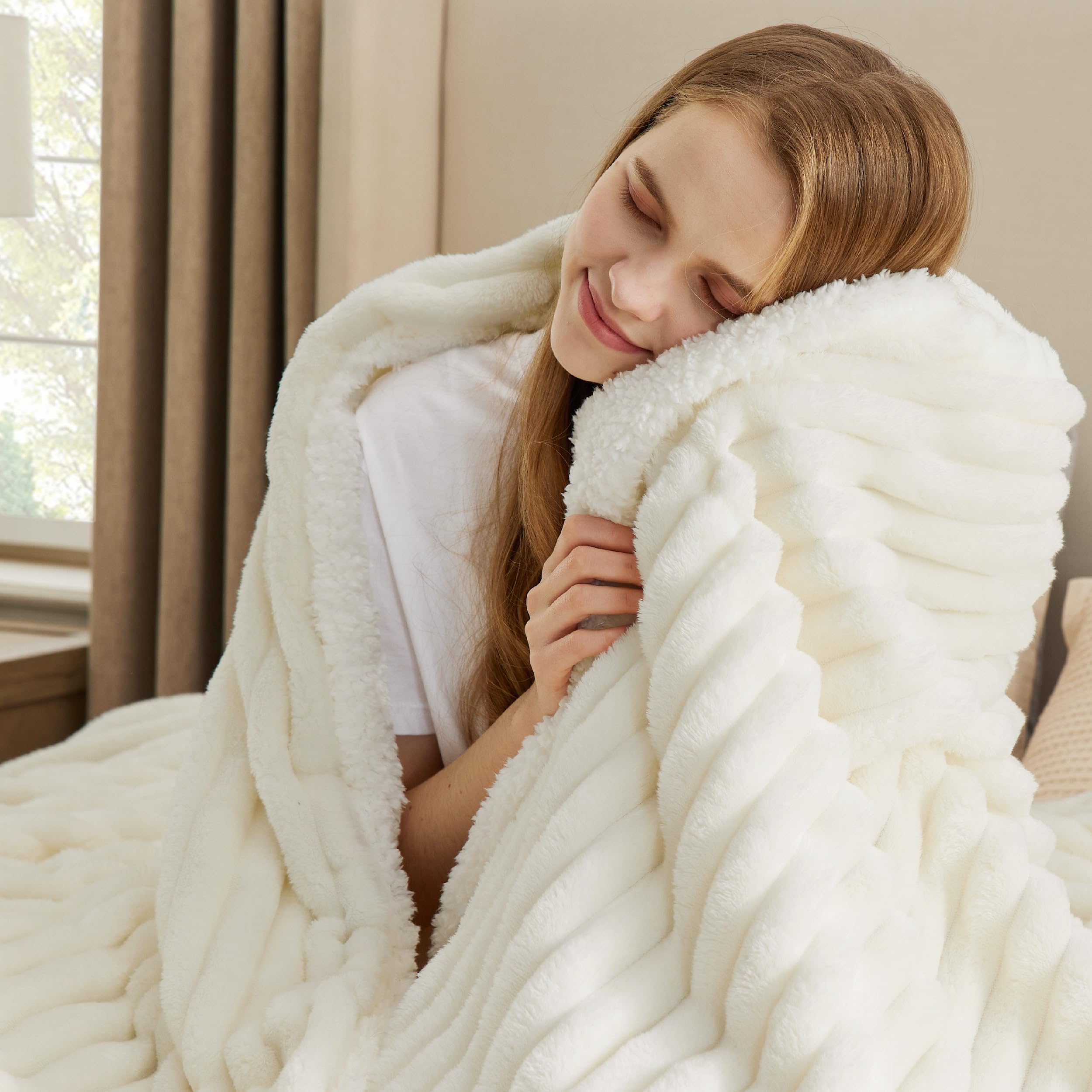 Bedsure sherpa throw blanket on a couch with stripe pattern complements living room decor.