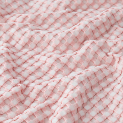 Bedsure spring pink blanket draped on bed with inviting cozy vibe.