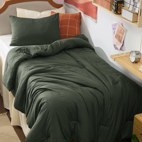 Bedsure Twin XL dark green comforter set on a dorm bed for all-season coziness.